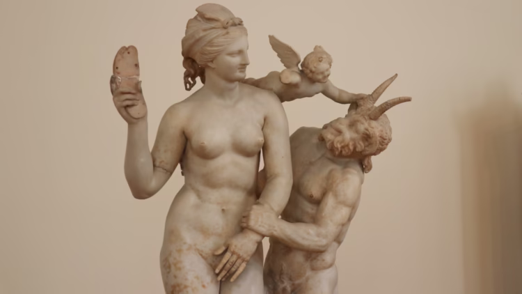 Marble group sculptures of Aphrodite, Pan, and Eros in the National Archaeological Museum in Athens Greece