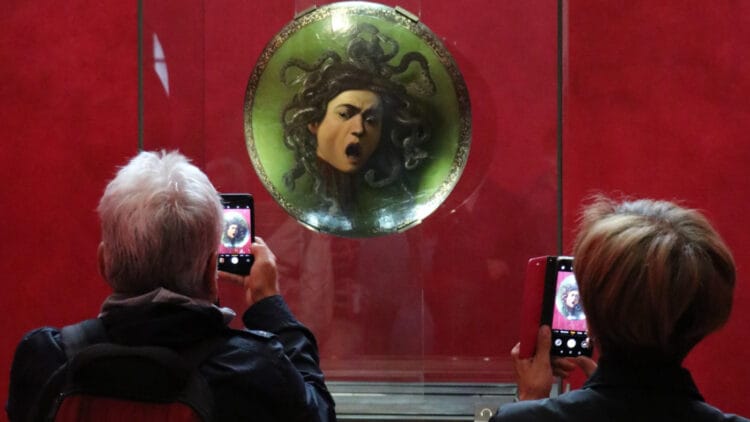 Two phone cameras with the Medusa by Caravaggio in the Uffizi